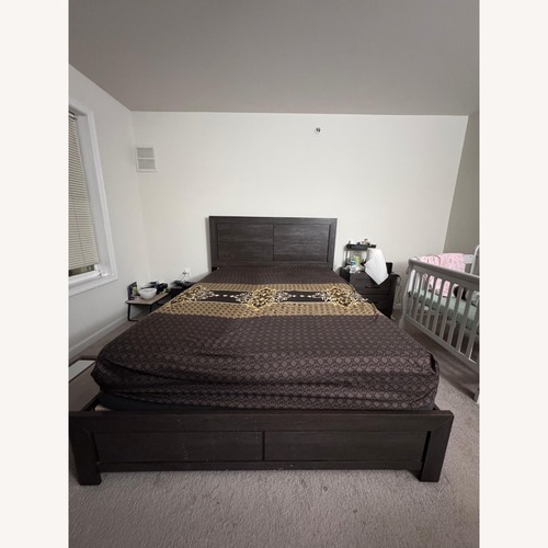 Used Raymour & Flanigan Dark Brown Wood Queen Bed for sale on AptDeco