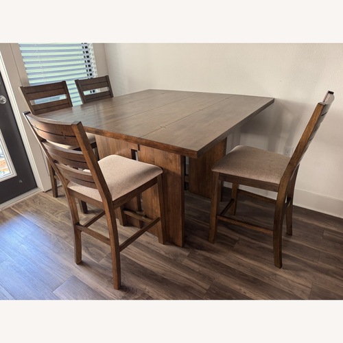 Used Living Spaces Lansing Dark Brown Wood Dining Table for sale on AptDeco