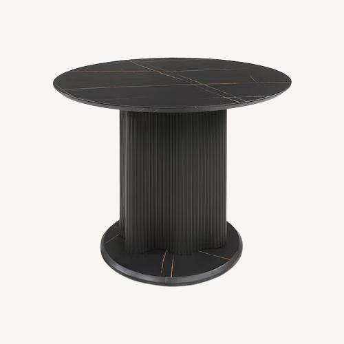 Used Black Faux Marble Dining Table with Fluted Base for sale on AptDeco