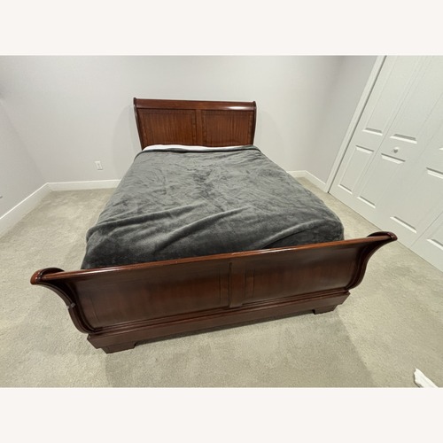 Used Raymour & Flanigan Dark Brown Wood Queen Bed for sale on AptDeco