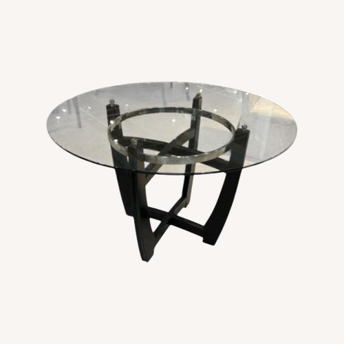 Used Modern Round Glass Top W Wooden Base Dining Table for sale on AptDeco