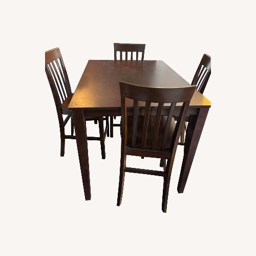 Used Dark Brown Wood Dining Table and 4 Chairs for sale on AptDeco