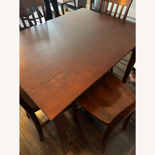 Used Dark Brown Wood Dining Table and 4 Chairs for sale on AptDeco