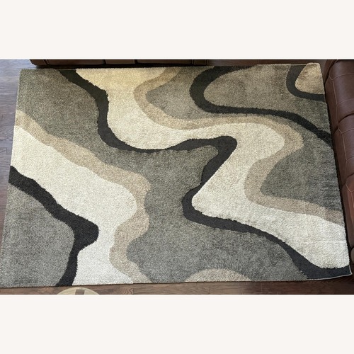 Used Rooms To Go Tetsu Light Brown Area Rug 7' x 10' for sale on AptDeco