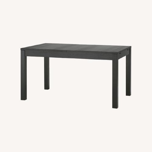 Used IKEA Bjursta Black Wood Dining Table for sale on AptDeco