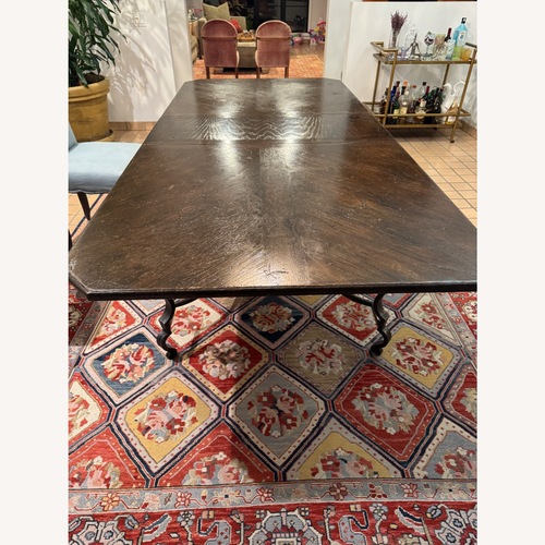 Used Vintage Dark Brown Dining Table Wrought Iron Base for sale on AptDeco