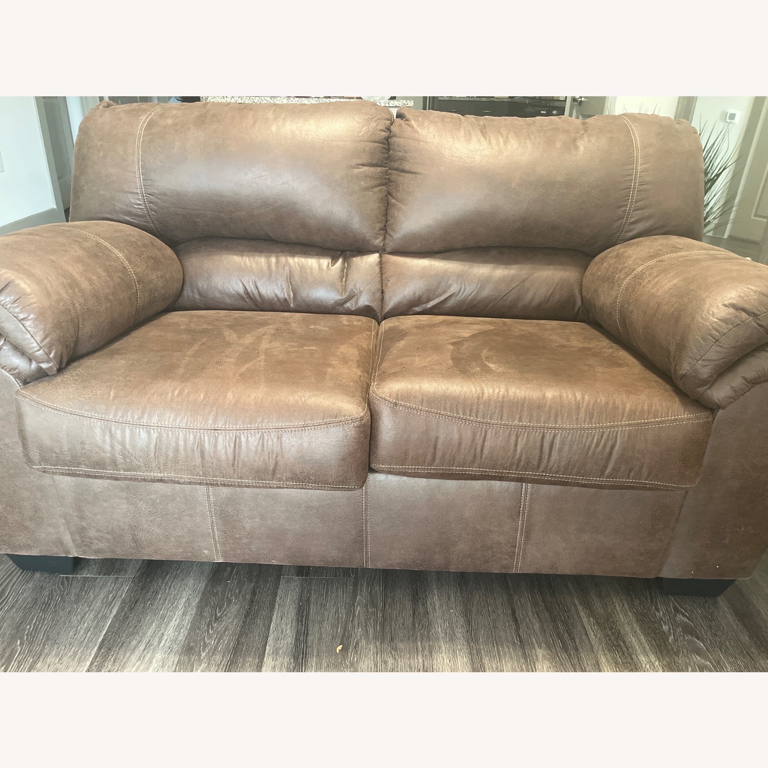 Image showcasing Ashley Furniture Bladen Dark Brown Loveseat - AptDeco