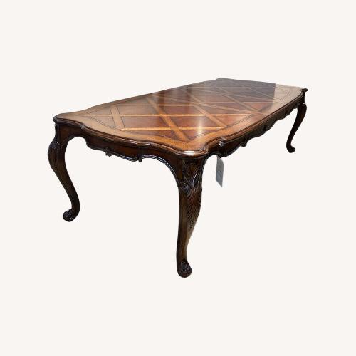 Used Solid Wood Parquet Style Dining Table for sale on AptDeco