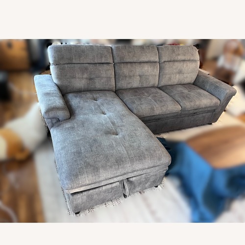Used Grey Sectional Sofa with Storage & Pull-Out Bed for sale on AptDeco