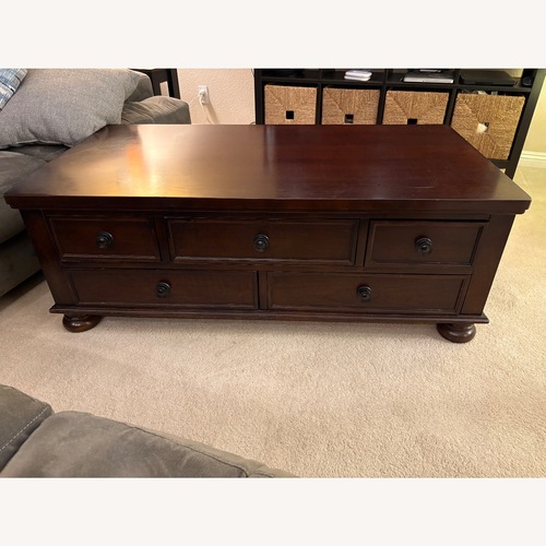 Used Living Spaces Dark Brown Wood Coffee Table for sale on AptDeco