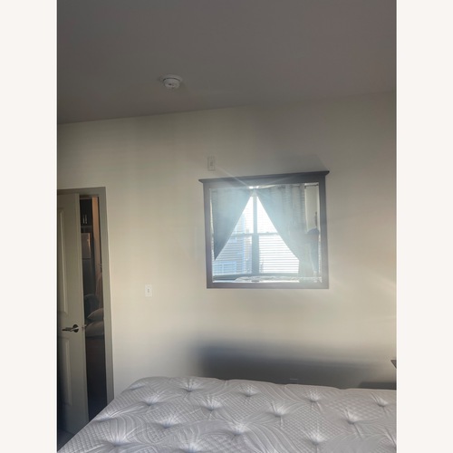 Used Dark Brown Glass Wall Mirror for sale on AptDeco