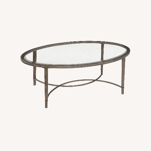 Used Raymour & Flanigan Copia Oval Glass Coffee Table for sale on AptDeco