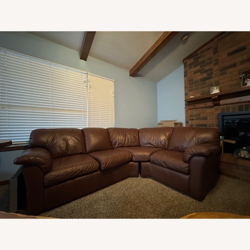 Used Brown Leather Curved Corner Sectional for sale on AptDeco