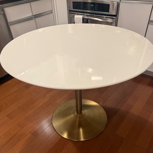Used CB2 Odyssey Round White Dining Table w Brass Base for sale on AptDeco