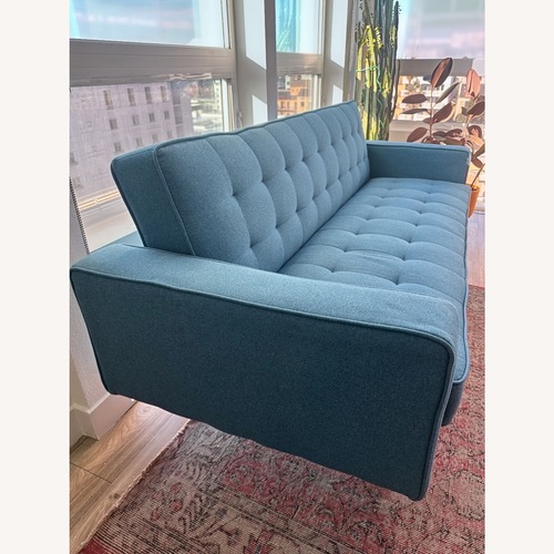 Used Living Spaces Mid-Century Modern Blue Futon Sofa  for sale on AptDeco