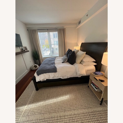 Used Raymour & Flanigan Dark Brown Wood Queen Bed for sale on AptDeco