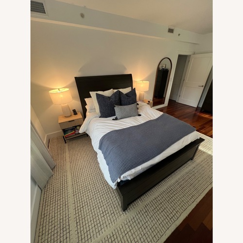 Used Raymour & Flanigan Dark Brown Wood Queen Bed for sale on AptDeco