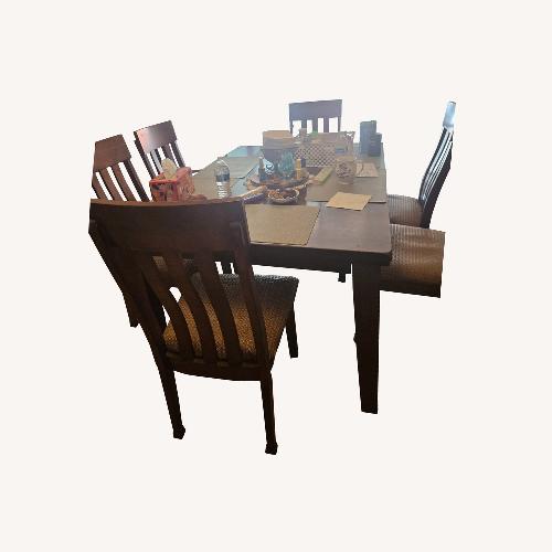 Used Dark Brown Wood Dining Table for sale on AptDeco