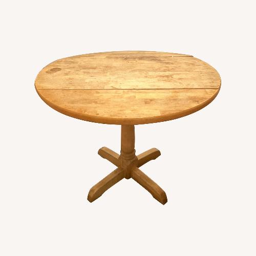 Used Round Dining Table with Folding Sides for sale on AptDeco