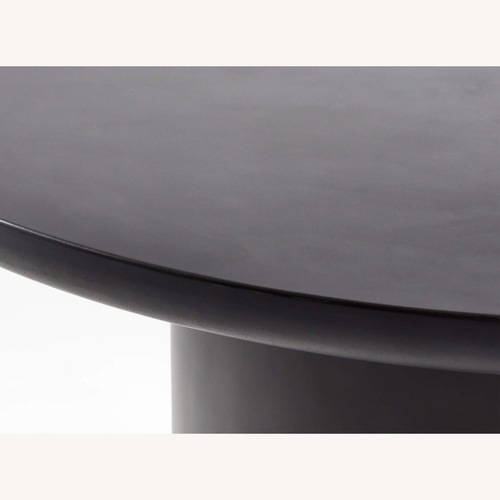 Used CB2 Lola 45" Round Black Concrete Dining Table for sale on AptDeco