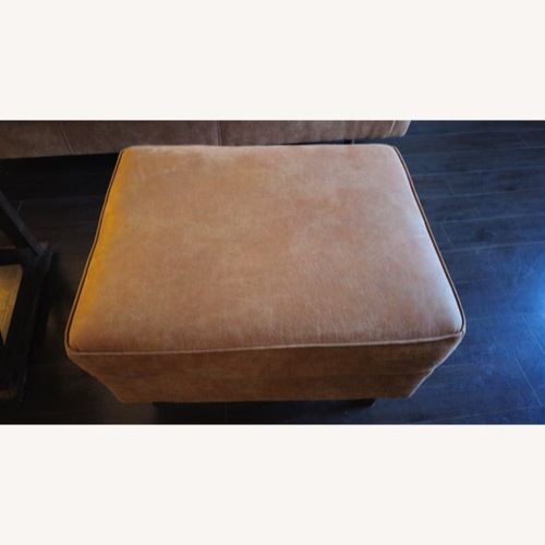 Used Ashley Maimz Caramel Faux Leather Ottoman for sale on AptDeco
