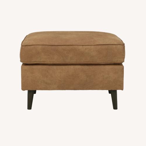 Used Ashley Maimz Caramel Faux Leather Ottoman for sale on AptDeco