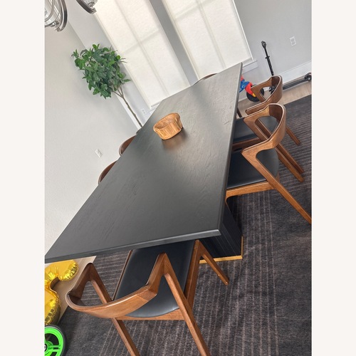 Used Black Wood Dining Table for sale on AptDeco