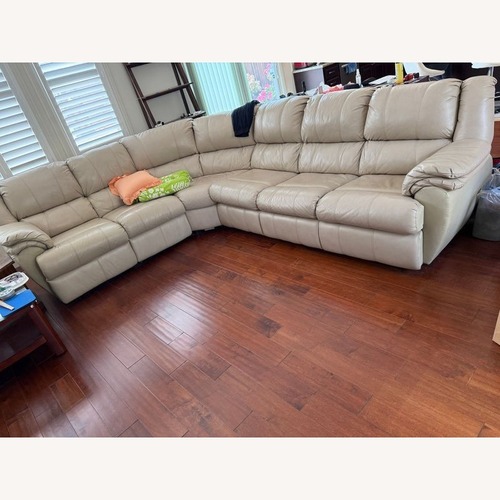 Used Ashley Leather Sectional with Recliner and Sleeper for sale on AptDeco