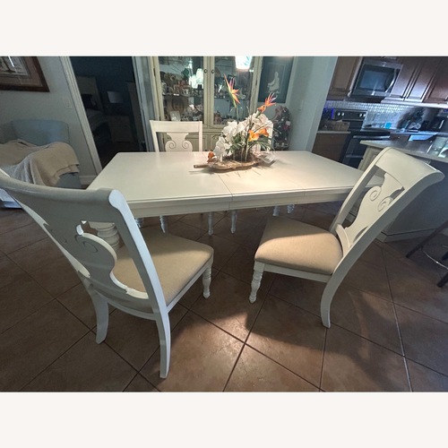 Used White Wood Dining Set with 4 Chairs and 2 Leafs for sale on AptDeco