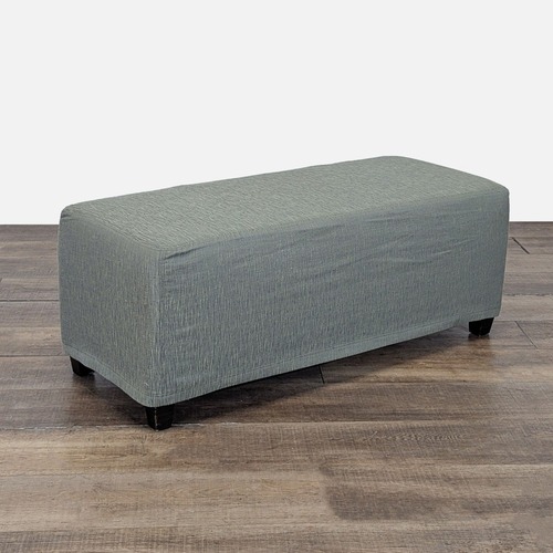 Used Slip Covered Ottoman on Wood Feet for sale on AptDeco