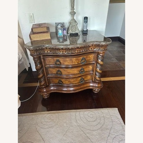 Used Heavily Carved Nightstand with Marble Top	 for sale on AptDeco