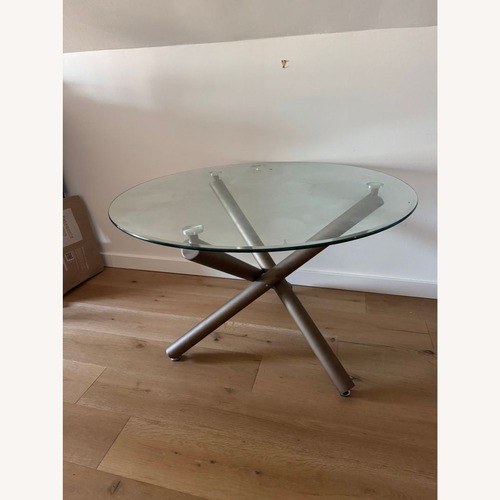 Used Glass Top Dining Table on Metal Base for sale on AptDeco
