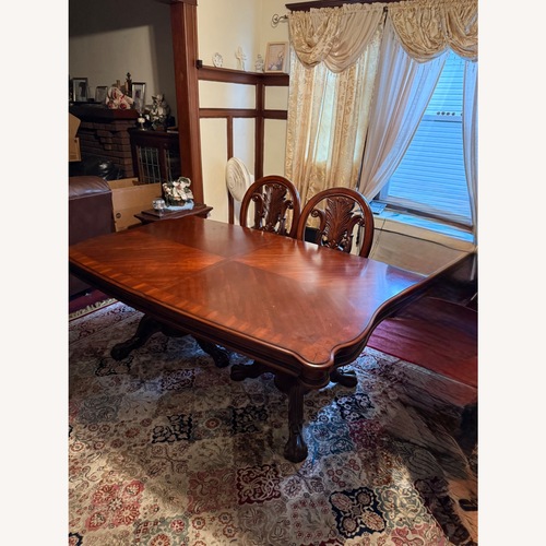 Used Ashley Furniture Red Wood Dining Table for sale on AptDeco