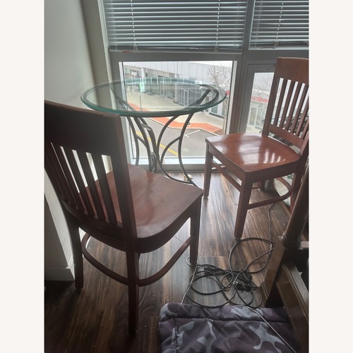 Used Glass Top Coffee Table with Iron Base for sale on AptDeco