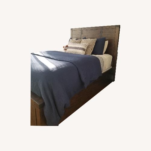 Used Raymour & Flanigan Dark Brown Wood Queen Bed for sale on AptDeco
