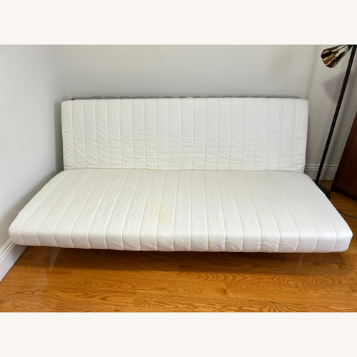 Used IKEA Beddinge White Metal/Wood Futon for sale on AptDeco