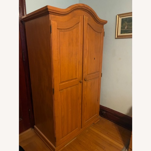 Used Light Brown Wood Armoire for sale on AptDeco