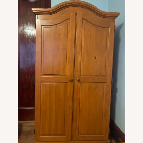 Used Light Brown Wood Armoire for sale on AptDeco