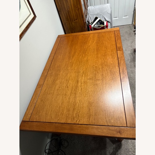 Used Dark Brown Wood Dining Table for sale on AptDeco