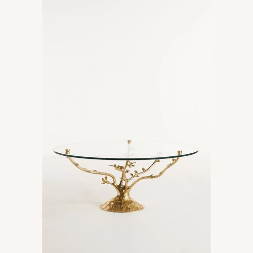 Used Anthropologie Gold Tree Glass Coffee Table for sale on AptDeco