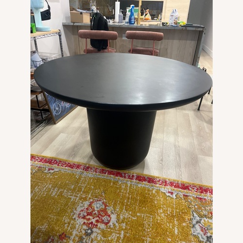 Used CB2 Lola Black Concrete Dining Table for sale on AptDeco