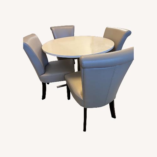Used Round Dining Table With Four Leather Chairs for sale on AptDeco