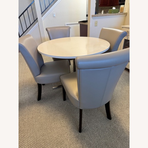 Used Round Dining Table With Four Leather Chairs for sale on AptDeco
