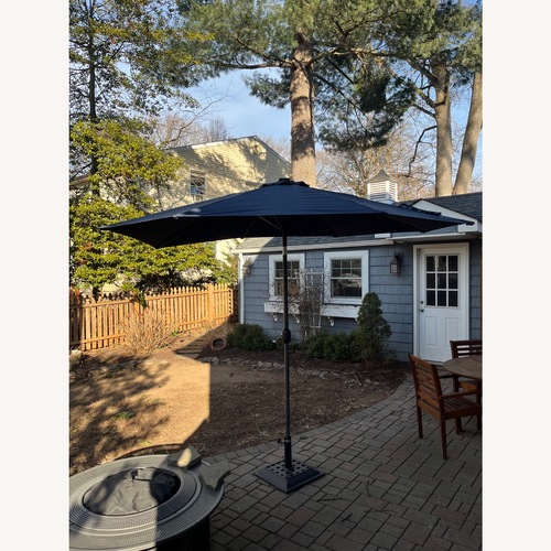 Used Amazon 9 Foot Umbrella with Stand and Solar Lights for sale on AptDeco