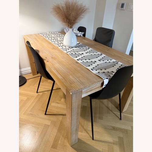 Used Article Natural Wood Dining Table with Black Chairs for sale on AptDeco