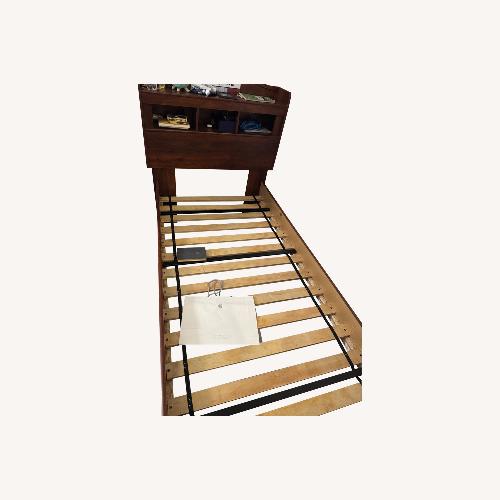 Used Raymour & Flanigan Dark Brown Wood Twin Bed for sale on AptDeco