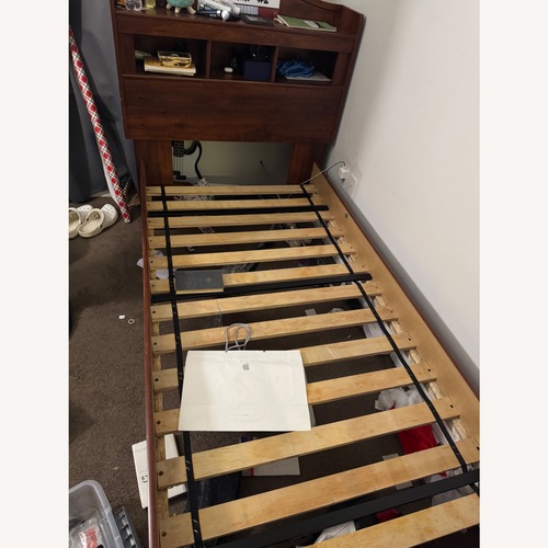 Used Raymour & Flanigan Dark Brown Wood Twin Bed for sale on AptDeco