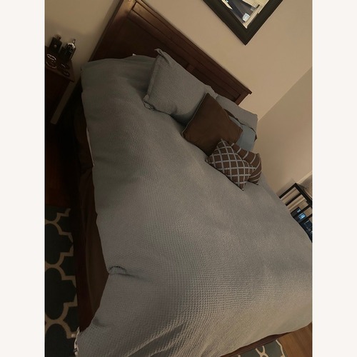 Used Dark Brown Wood Queen Bed for sale on AptDeco
