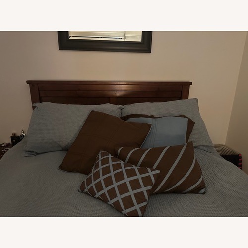 Used Dark Brown Wood Queen Bed for sale on AptDeco