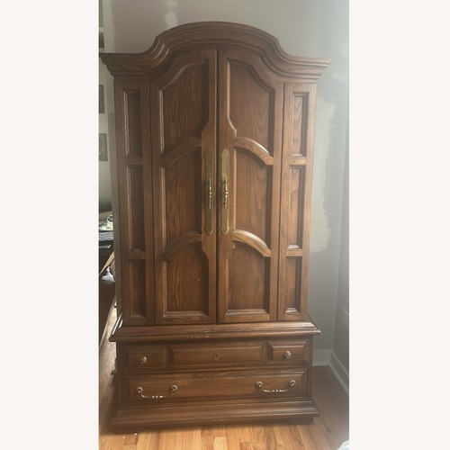 Used Vintage/Antique Dark Brown Solid Wood Armoire for sale on AptDeco